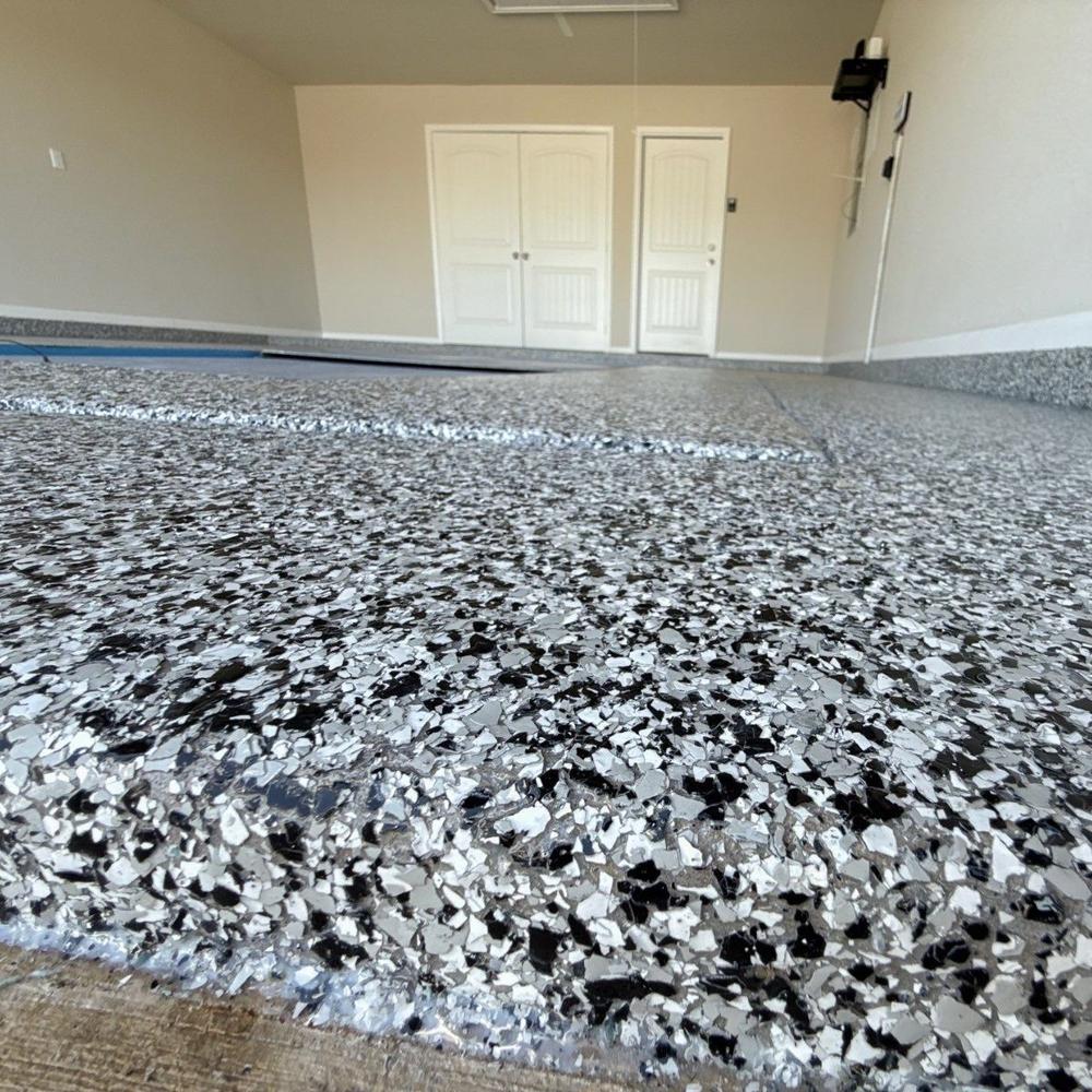 Dramatic close-up of finished black and white color flake epoxy floor