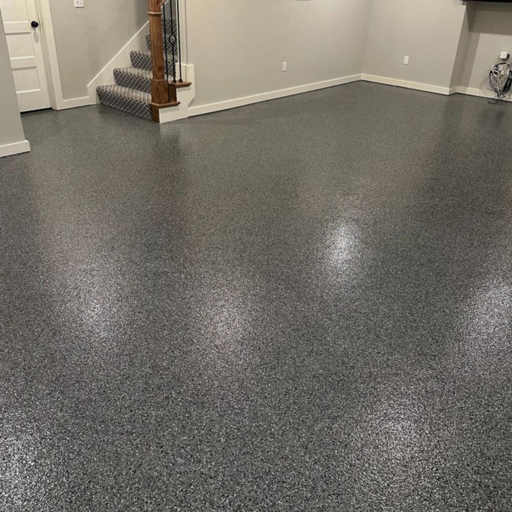 Basement with dark gray epoxy floor and staircase