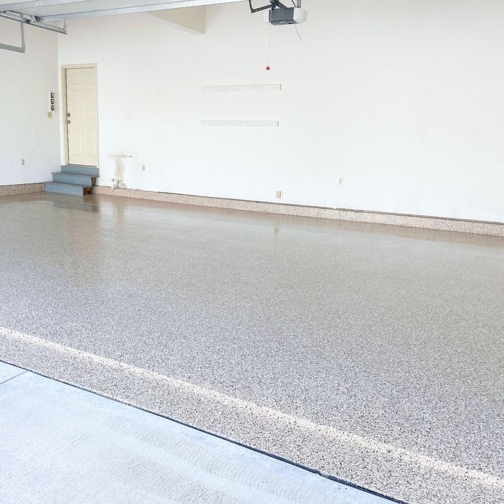 Clean residential garage with beige flake epoxy floor