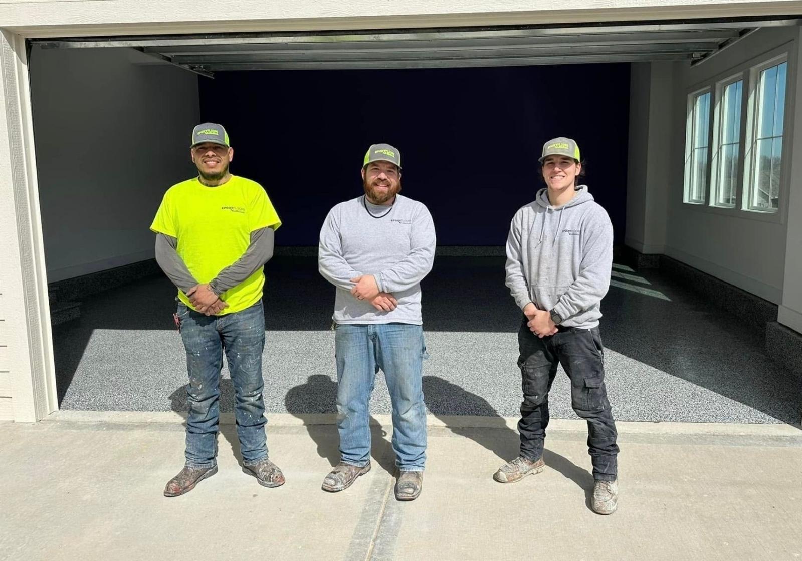 The Epoxy Floors by Welch crew standing in front of a finished garage